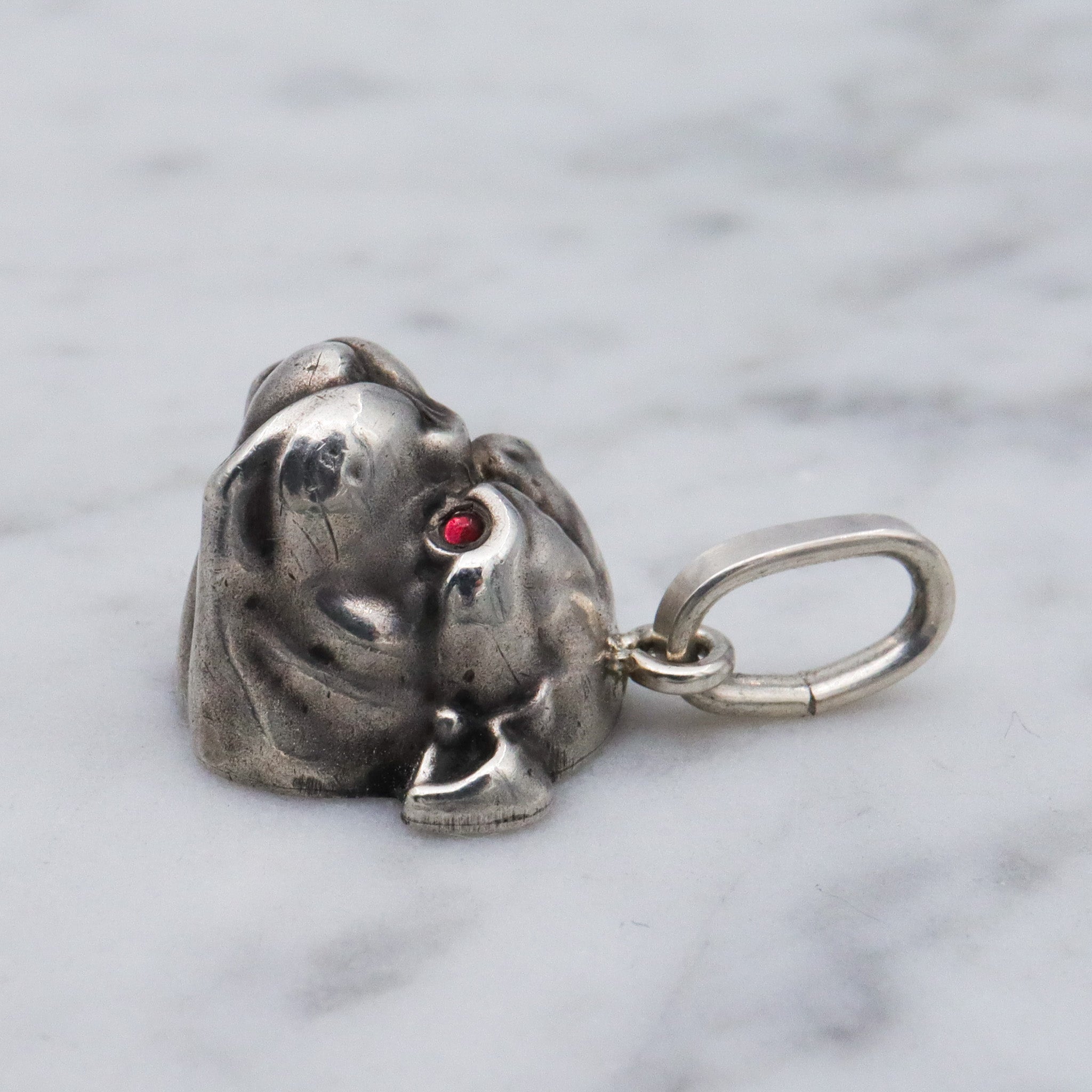 Antique Unger Brothers sterling silver bulldog with ruby glass eyes pendant